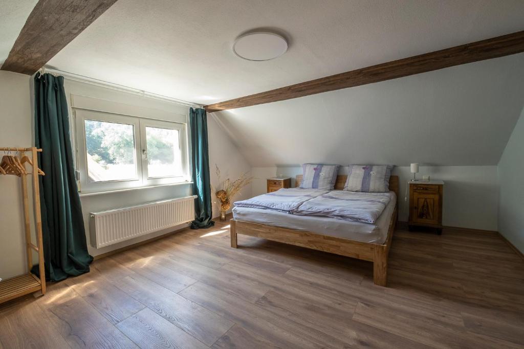 a bedroom with a bed and a window at Ferienhaus Zum Waldrand in Erfweiler