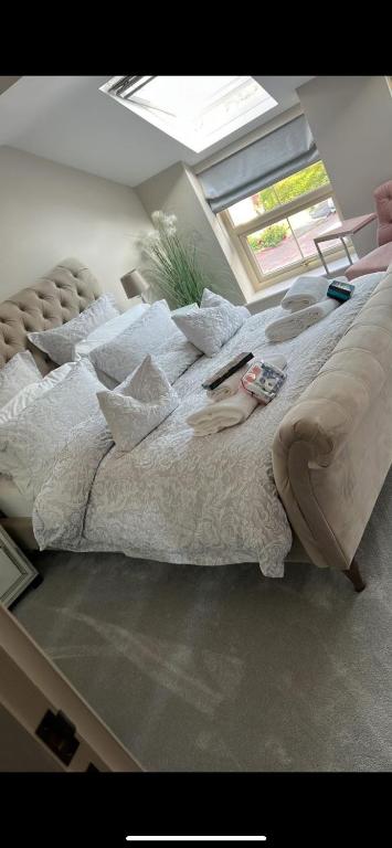 a large bed in a room with a window at Sleeps 7, entire apartment,with restaurant next door in Ebchester