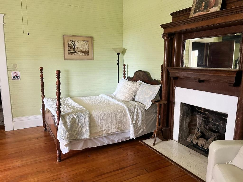 a bedroom with a bed and a fireplace at Belton Bed and Breakfast in Belton