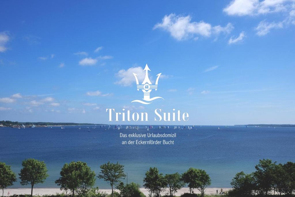 a sign for a resort on a body of water at Triton Suite in Eckernförde