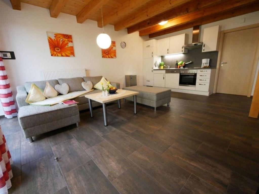 a living room with a couch and a table at Ferienwohnung 6 in Ochsenhausen