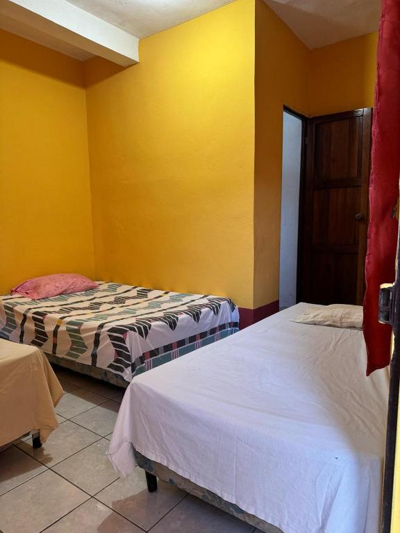 Postel nebo postele na pokoji v ubytování Gually Hostel
