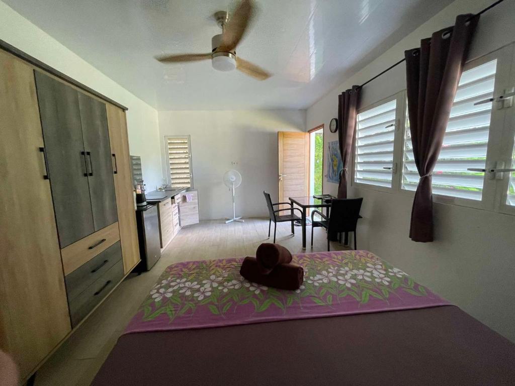 a bedroom with a bed with a hat on it at Bora Bora Fare Sophia in Bora Bora