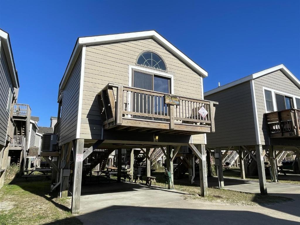 a large house with a deck on the side of it at NC 12 56821-15 Condo in Hatteras