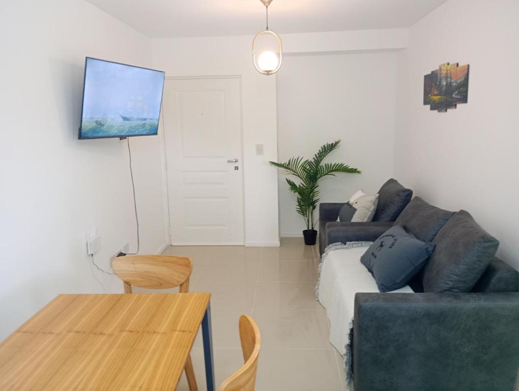 a living room with a couch and a table at Dpto zona pelegrini 1 dormitorio cochera opc in Rosario