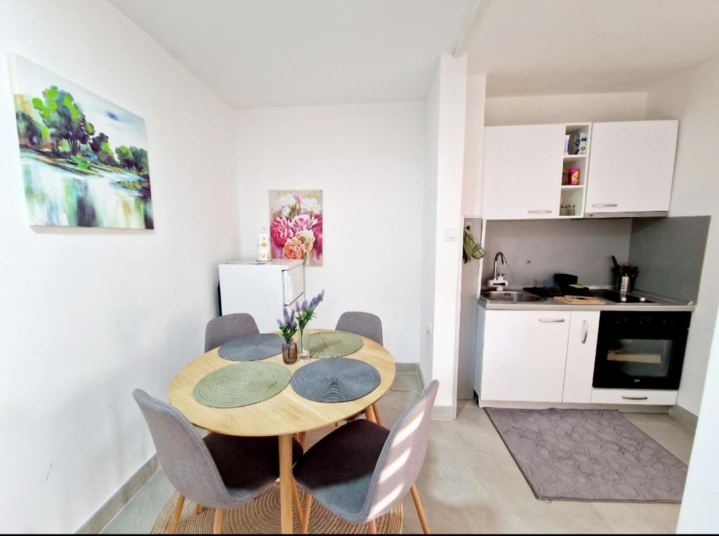 a kitchen and dining room with a table and chairs at Infinity Apartment & Free Wifi & Free Parking in Sarajevo