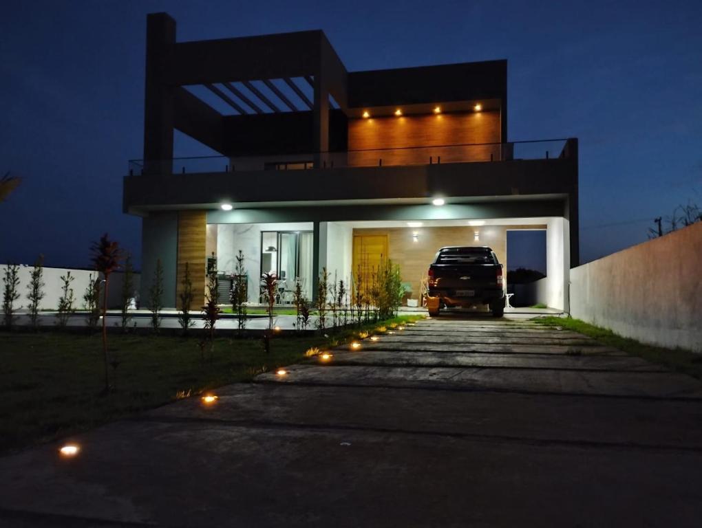 a car parked in front of a house at night at Family home in Paranapanema