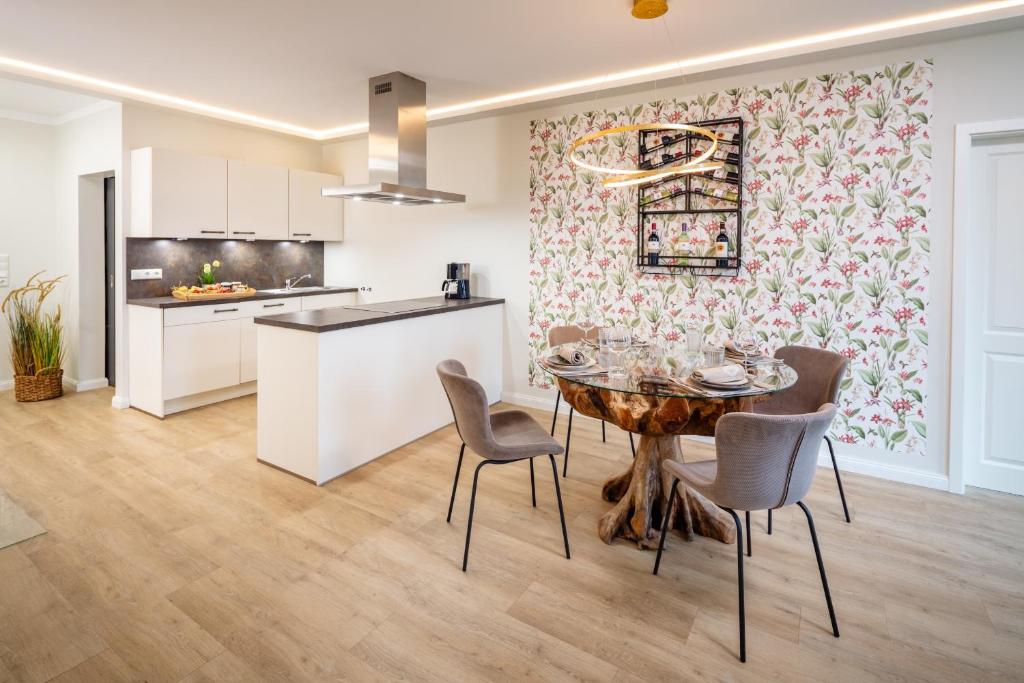a kitchen and dining room with a table and chairs at Osterhof Fehmarn - Casa Florale in Fehmarn