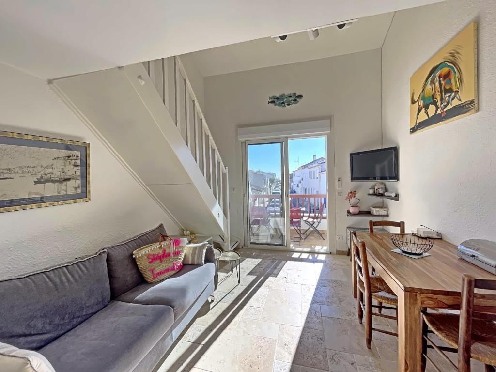 un salon avec un canapé et une table dans l'établissement Appartement climatisé 4 pers avec parking, proche mer - FR-1-475-203, à Saintes-Maries-de-la-Mer