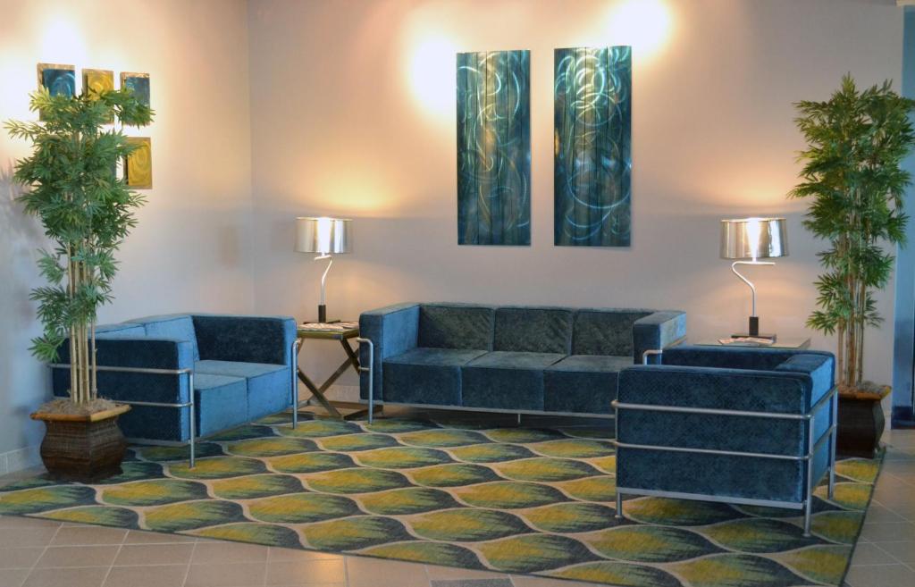 a living room with two blue couches and palm trees at Avista Resort in Myrtle Beach