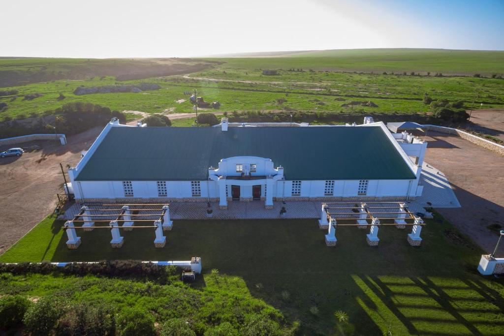 an overhead view of a large building with benches at Togryersvlei Venue & Guest House in Jacobs Bay