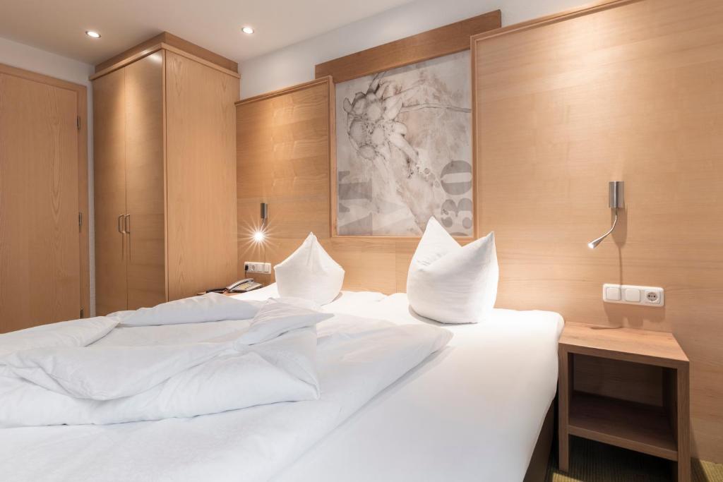 Posteľ alebo postele v izbe v ubytovaní SCHMID Rooms & Apartments
