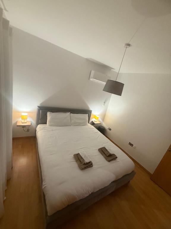 a bedroom with a bed with two towels on it at La Vie Royale in Nicosia