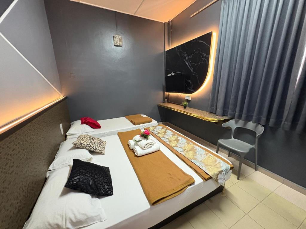 Postel nebo postele na pokoji v ubytování Weng Kong Hotel