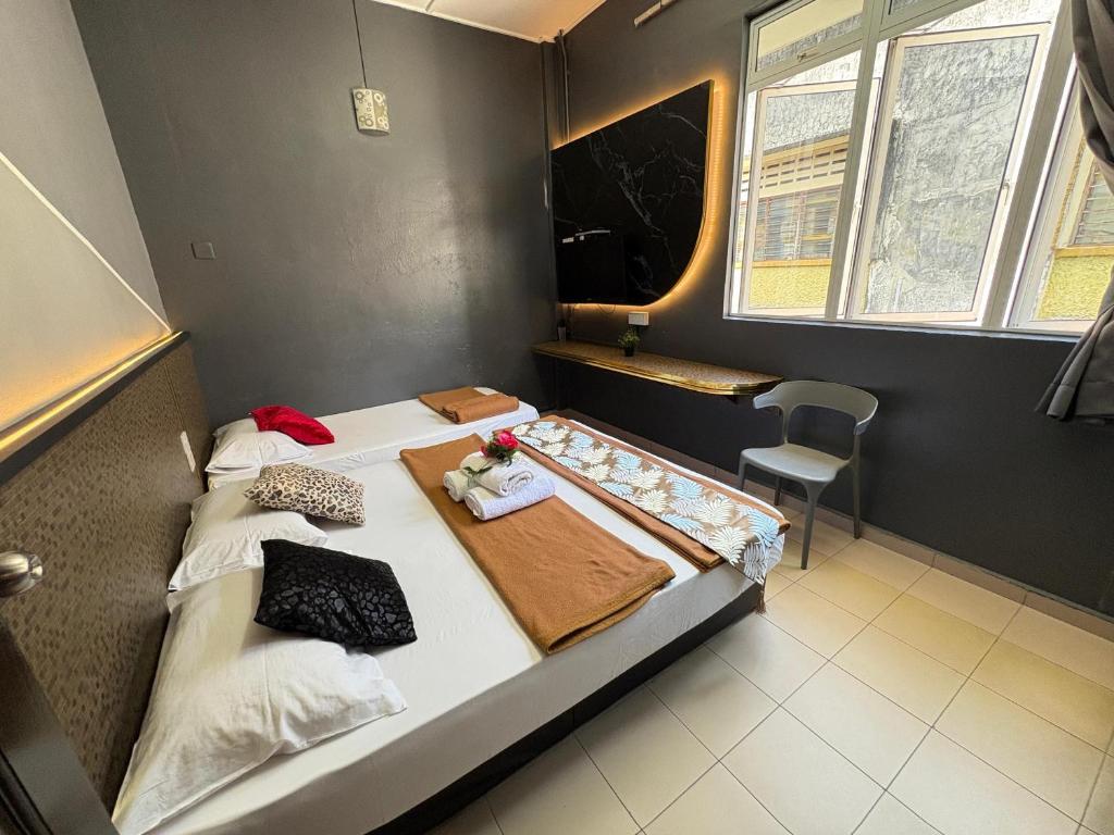 Postel nebo postele na pokoji v ubytování Weng Kong Hotel