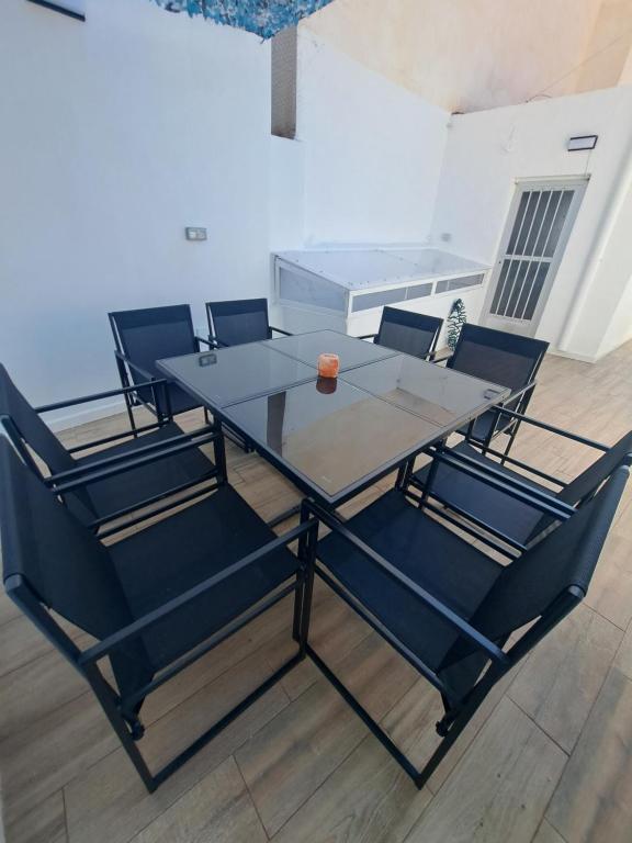 a glass table and chairs in a living room at La Casita de Ana in Águilas