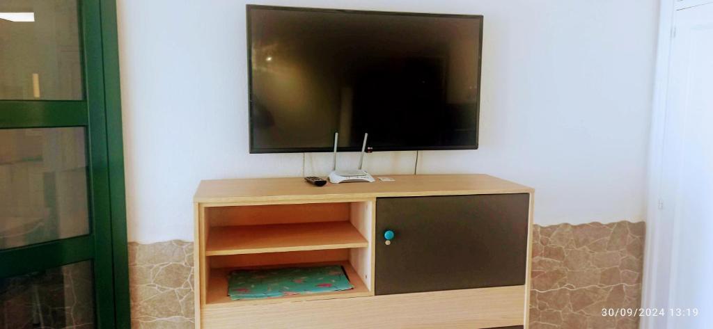 Televízia a/alebo spoločenská miestnosť v ubytovaní Casa Lucia