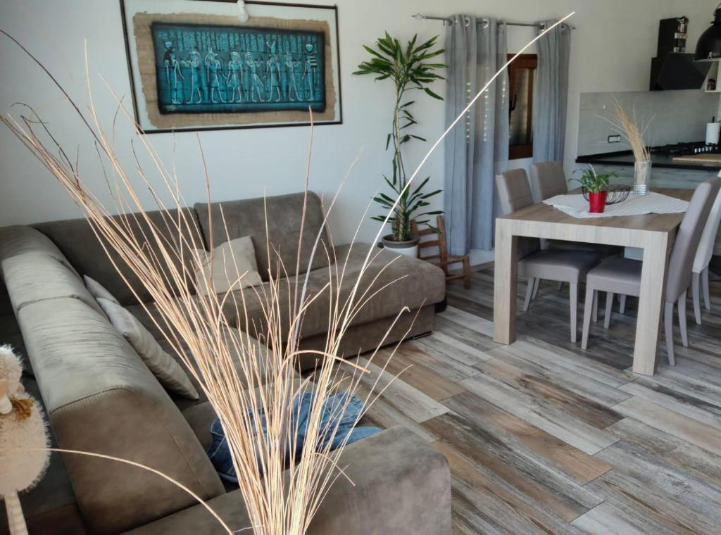 a living room with a couch and a table at Le pietre di Mario in Bari Sardo