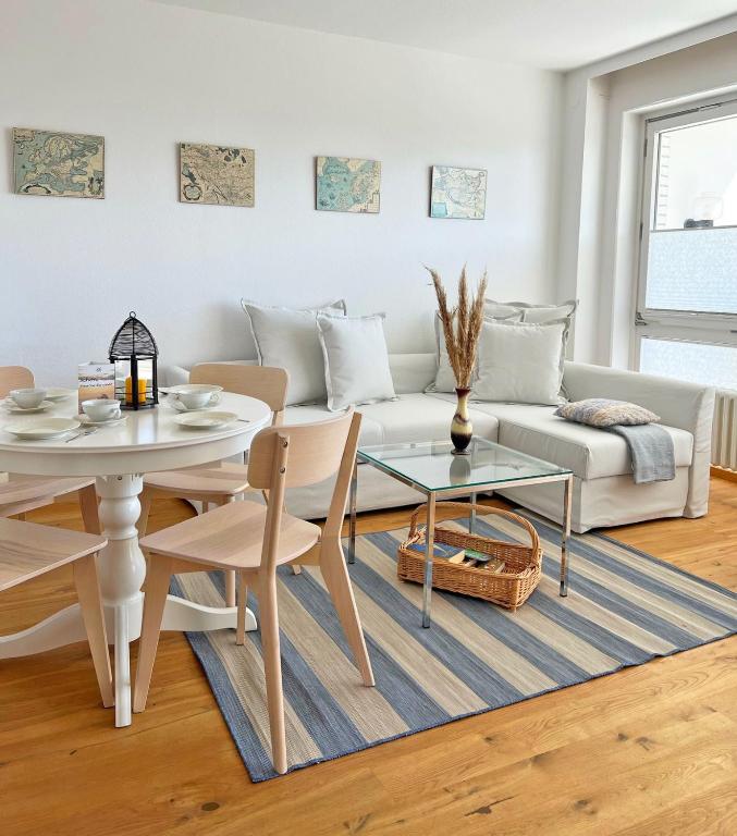 a living room with a white couch and a table at Haus Grömitz Wohnung 15 in Grömitz