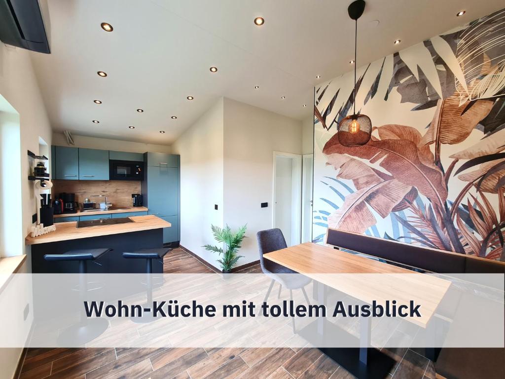 a kitchen and dining room with a large painting on the wall at Ferienhaus Rothsee-Oase in Roth