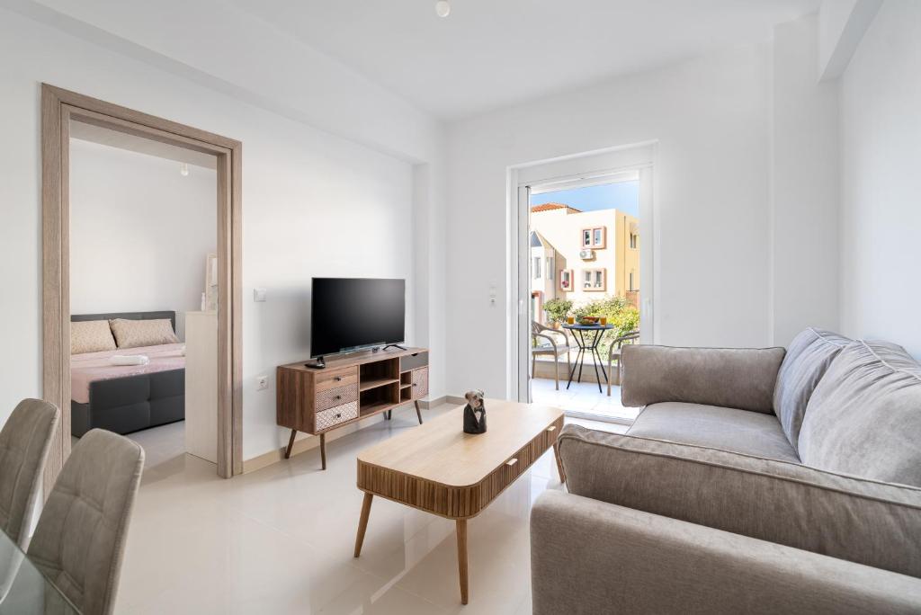 a living room with a couch and a table at Brand New House Sitia in Sitia