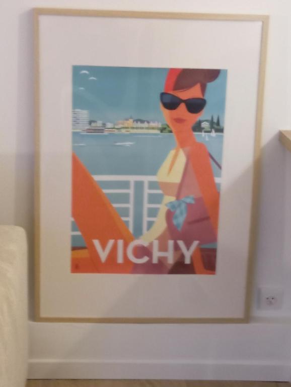 une photo d'une femme portant des lunettes de soleil et une planche de surf dans l'établissement Véronique et David, à Vichy
