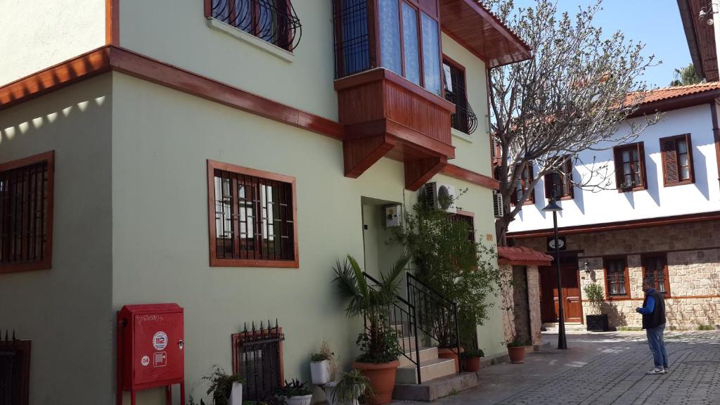 a person standing in front of a building at Camel Apartment in Antalya