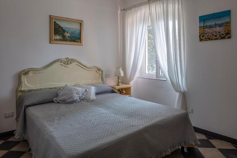a bedroom with a bed and a window at La BRIGNA B&B Il bosco sul mare in Genoa