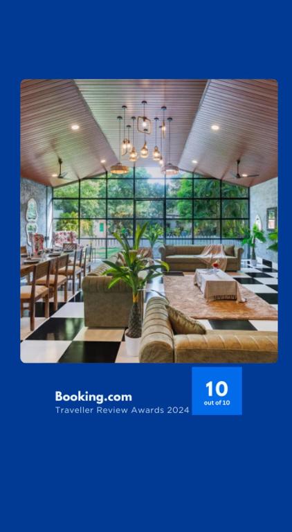 a large room with a table and chairs and windows at Ekostay Jungle Beach Villa I 1 Acre Property I 100 Meters from the Beach in Alibaug