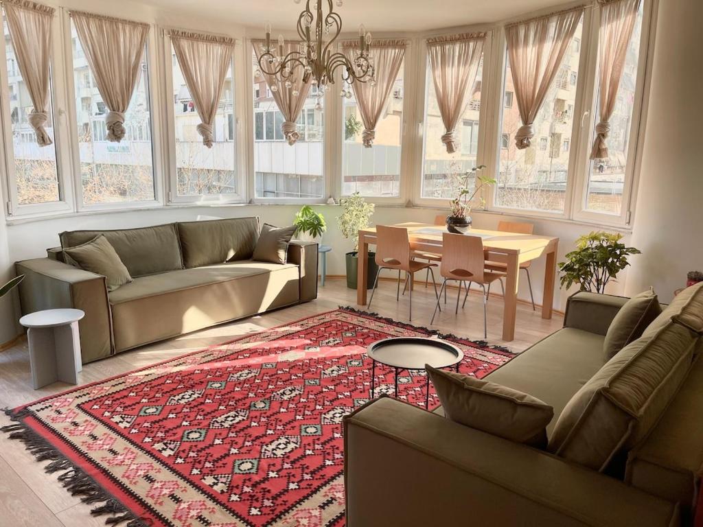 a living room with a couch and a table at Capital Apartment Tirana in Tirana