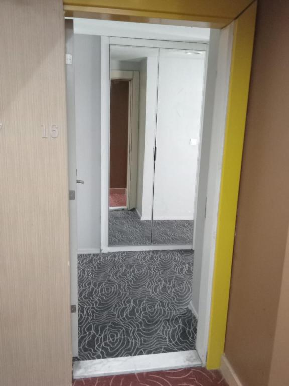 a hallway with a mirror in a room at Hanzade Turizm in Istanbul