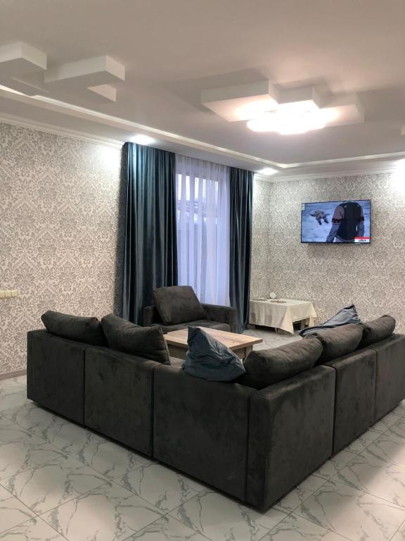 a living room with a large couch and a table at Veni Vedi in Vedi