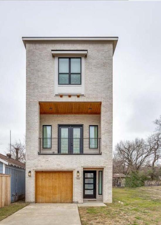 a large brick house with a garage at Muncie U Too at Trinity Grove in Dallas