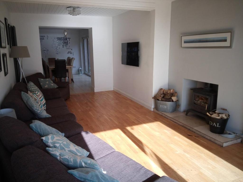 a living room with a couch and a fireplace at Burntisland Near Edinburgh with Hot Tub in Burntisland
