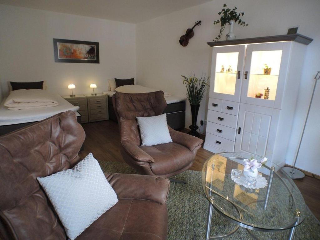 salon z kanapą i szklanym stołem w obiekcie Melody -303- w mieście Mittenwald