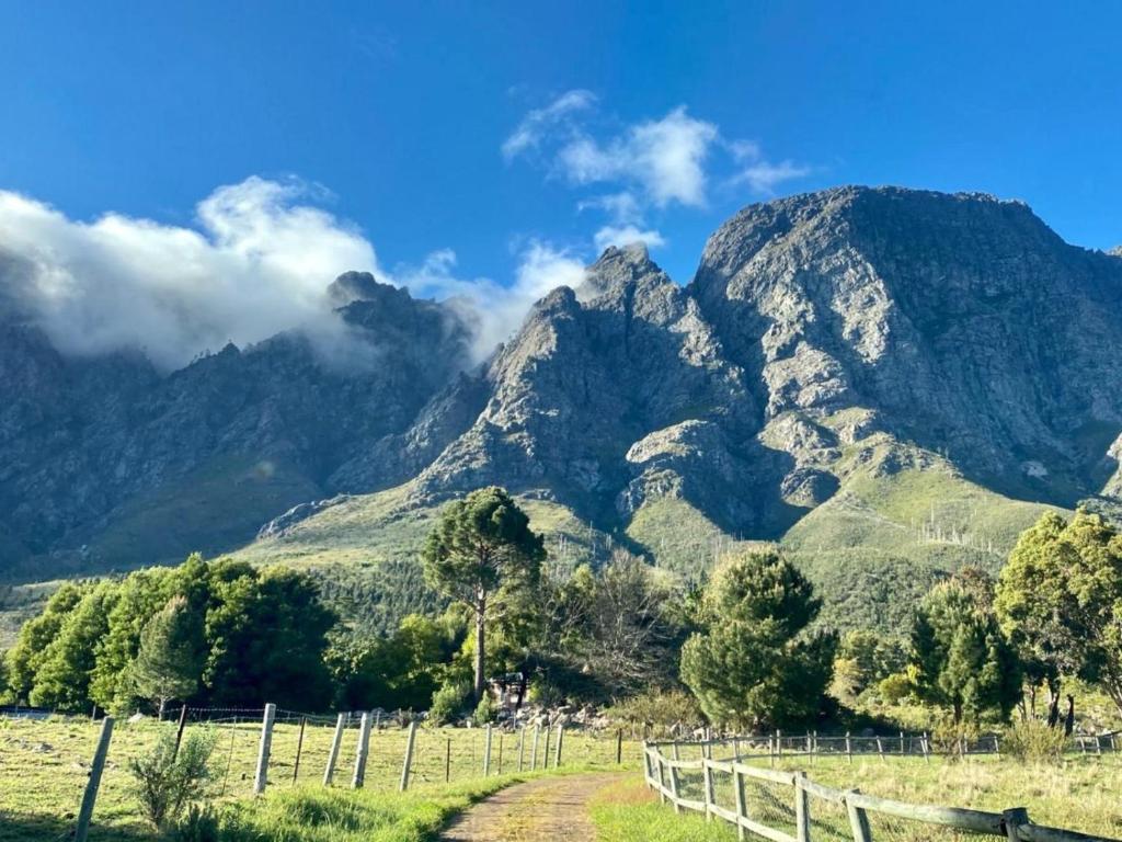 a mountain range with a fence in front of it at Stonehedge Cottages in Franschhoek