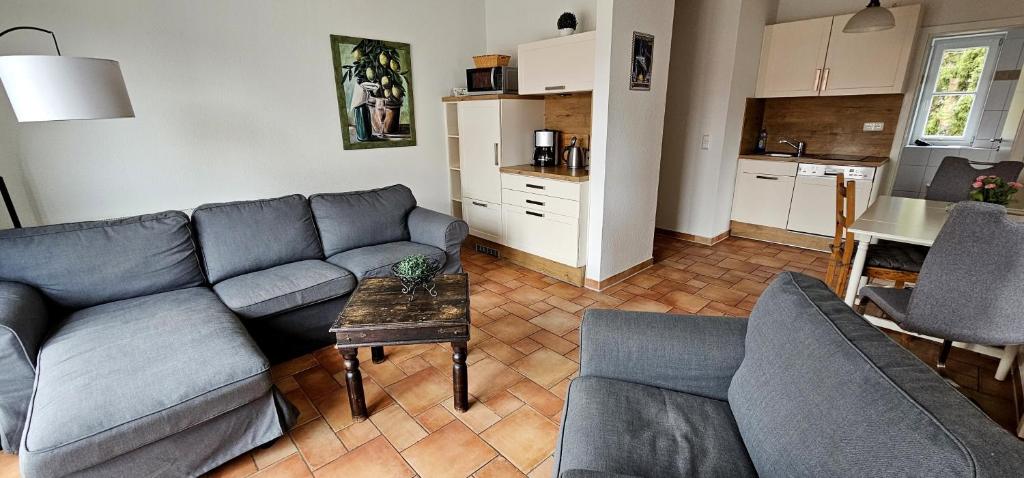 a living room with a couch and a table at Seeadler I in Dierhagen