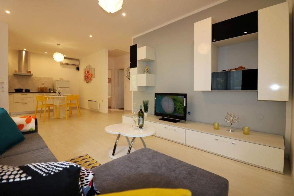 a living room with a couch and a tv at Melisa 5 in Poreč