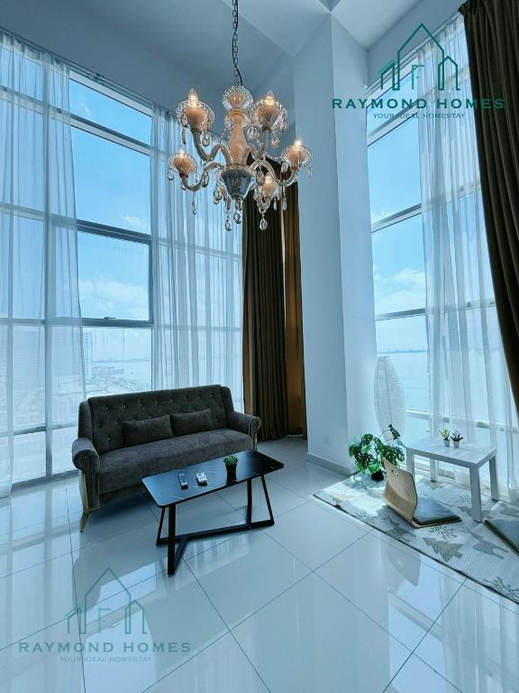 a living room with a couch and a chandelier at Maritime Sea View Duplex in George Town