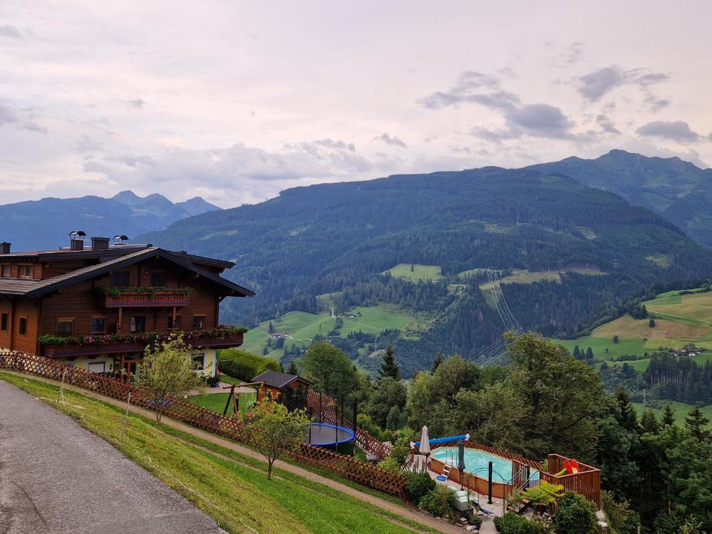 a house on a hill with a view of a mountain at Appartements Hinterkerschbaum in Kleinsonnberg