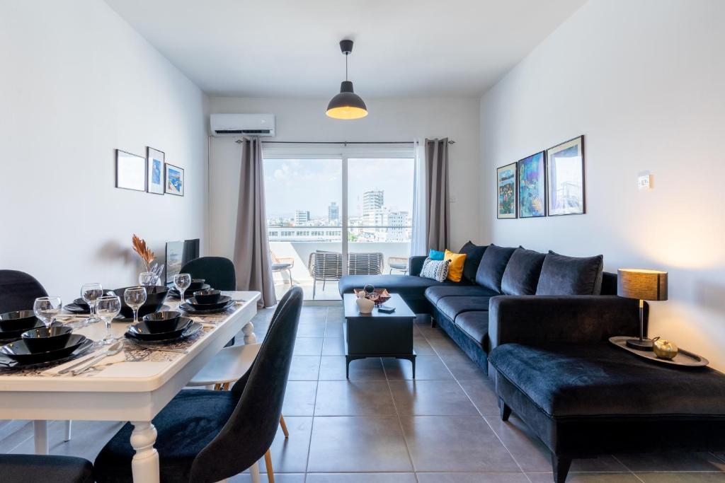 a living room with a couch and a table at Snobby 2-Bedroom Apartment in Larnaca