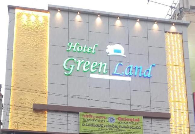a hotel green land sign on the side of a building at Hotel Greenland in Khammam