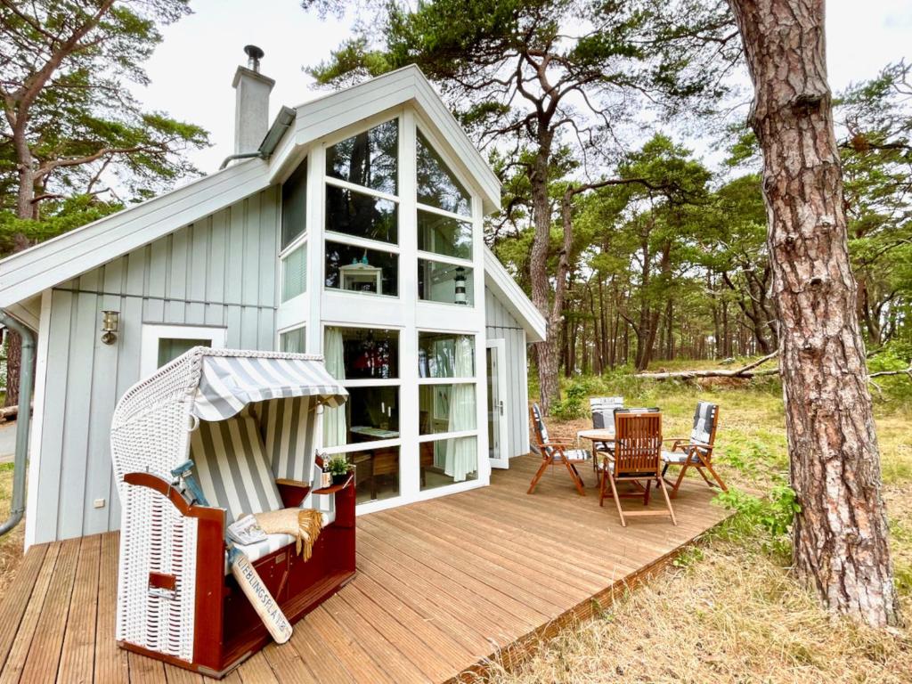 a screened in porch with a table and chairs on a deck at Sandrose - Baabe in Baabe
