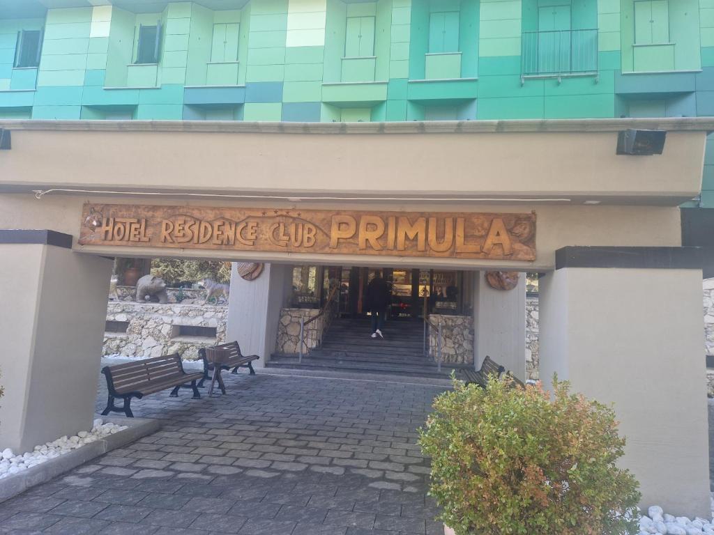 a entrance to a building with a sign on it at ACAMPORA CIRO Appartamento Privato Club Primula in Pescasseroli