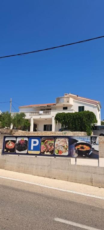 a wall with pictures of food on the side of a street at Dome&Mare in Slatine
