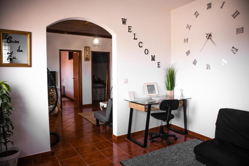 a room with a desk and a clock on the wall at Casa Da Zu in Tomar