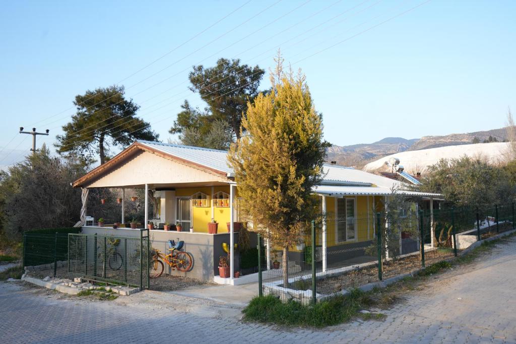a yellow house on the side of a street at Çilek Home in Pamukkale