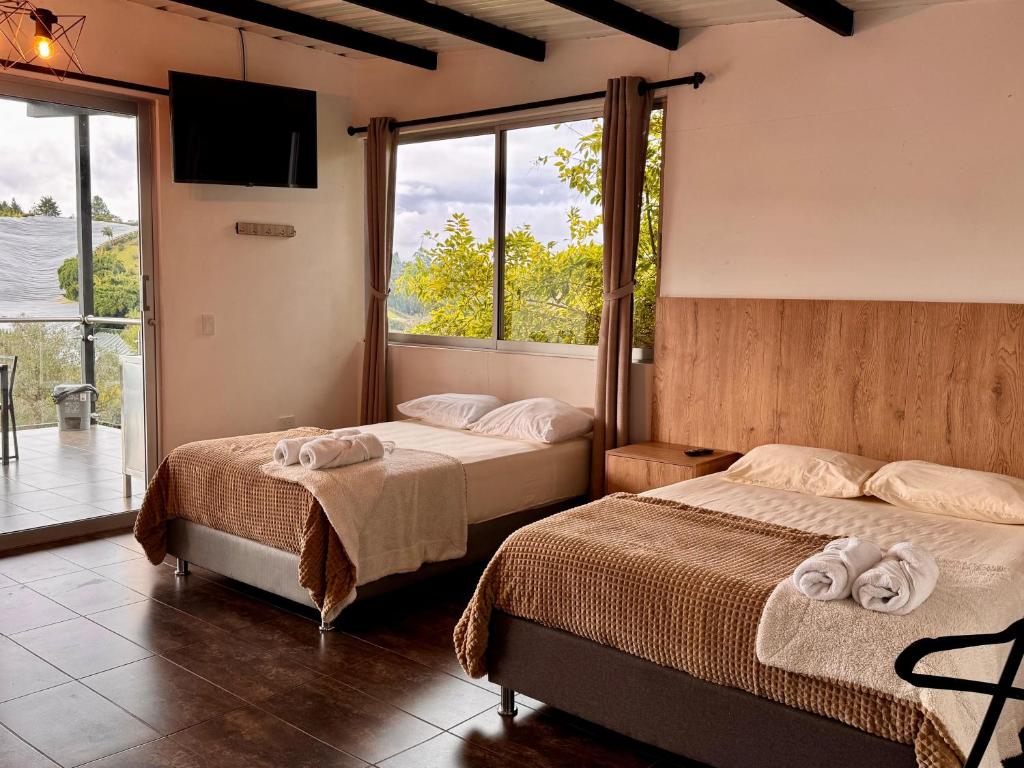 Postel nebo postele na pokoji v ubytování Hotel Campestre Alto lindo en Guatapé