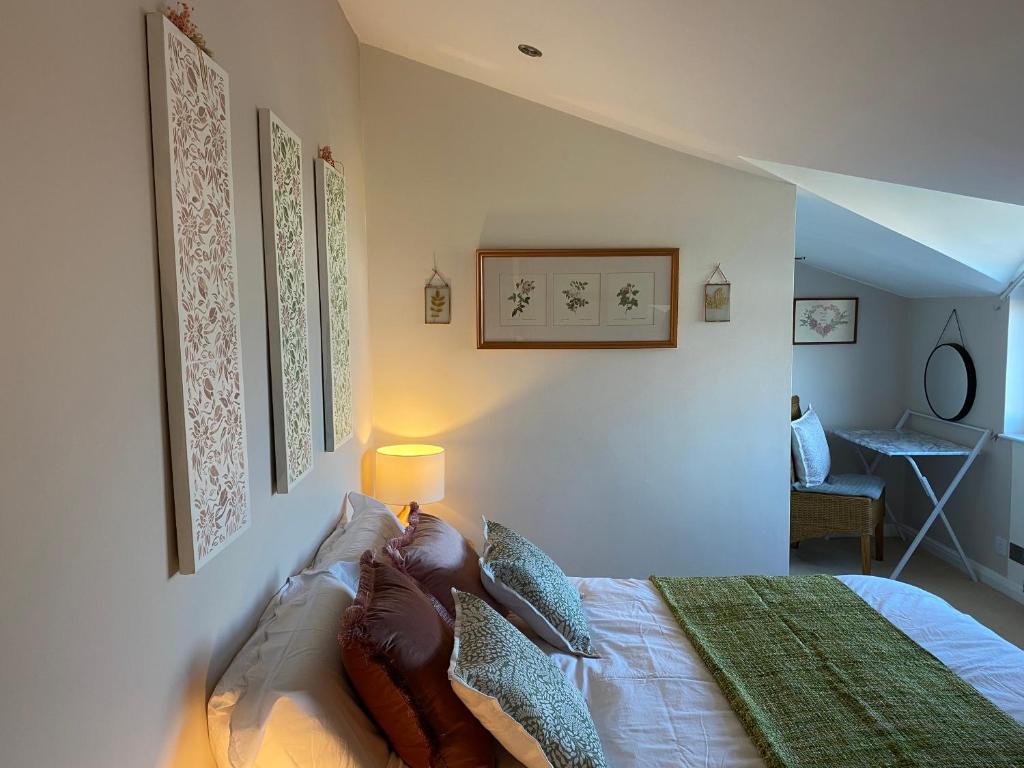 a bedroom with a bed with a lamp on it at Cottage Guest House Nr Cheltenham on Cotswold Edge in Churchdown
