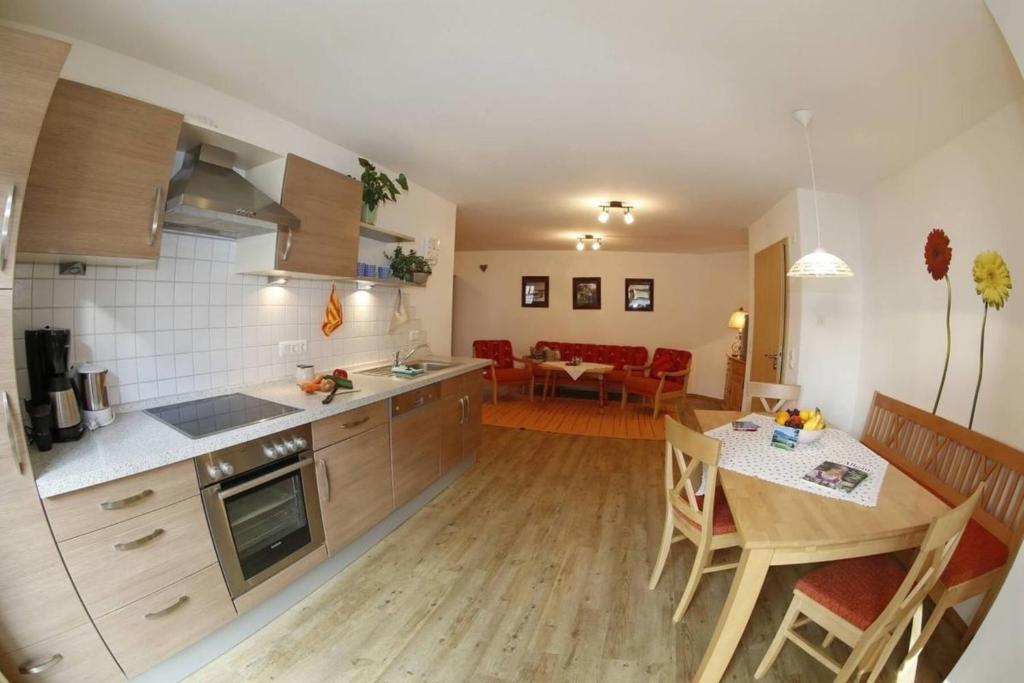 a kitchen and dining room with a table and a dining room at Ferienwohnung Heublume, Ferienhof Lochbihler, WertachAllgäu in Wertach